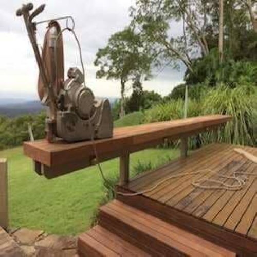 A Machine is Sitting on Top of a Wooden Deck — Maroochy Floor Sanding in Nambour, QLD