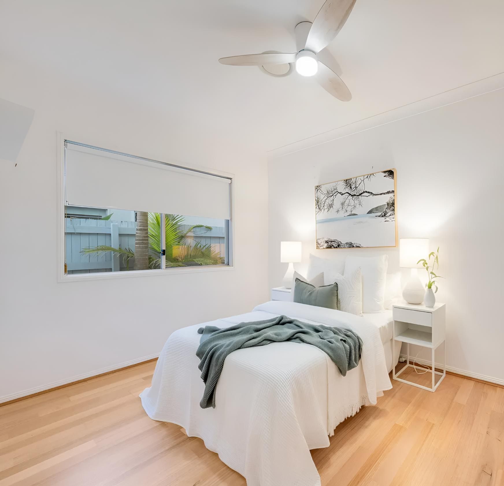 Bedroom With a Bed and a Ceiling Fan — Maroochy Floor Sanding in Nambour, QLD