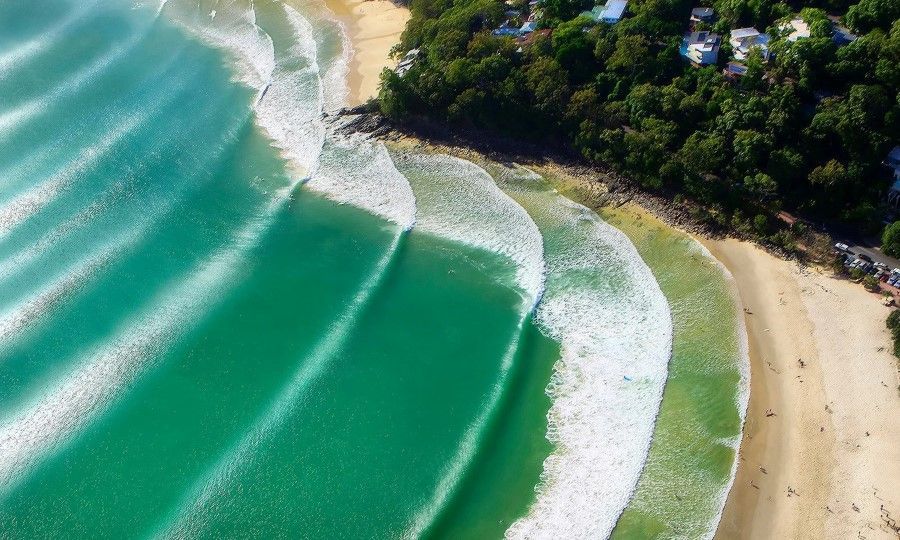 An Aerial View of a Beach With Waves Crashing on the Shore — Maroochy Floor Sanding in Noosa, QLD