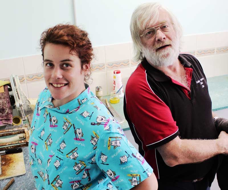 Technicians smiling at the camera and getting ready to work on new denture moulds - Fabricating Dentures in Toukley, NSW