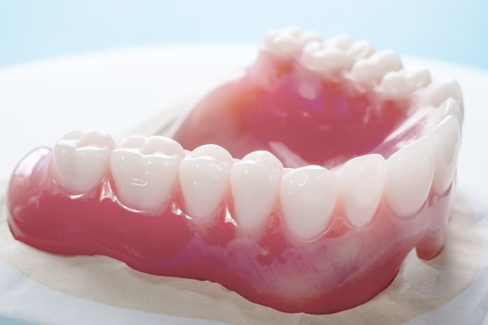 A Close-up of a Set of Upper Dentures With White Teeth and Pink Gums
