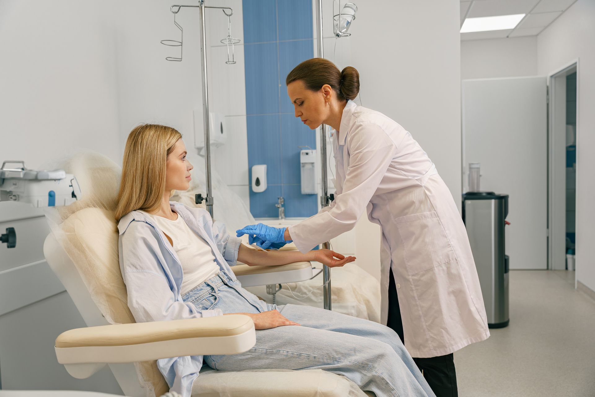 A person is pointing at an EKG monitor with a heartbeat on it.