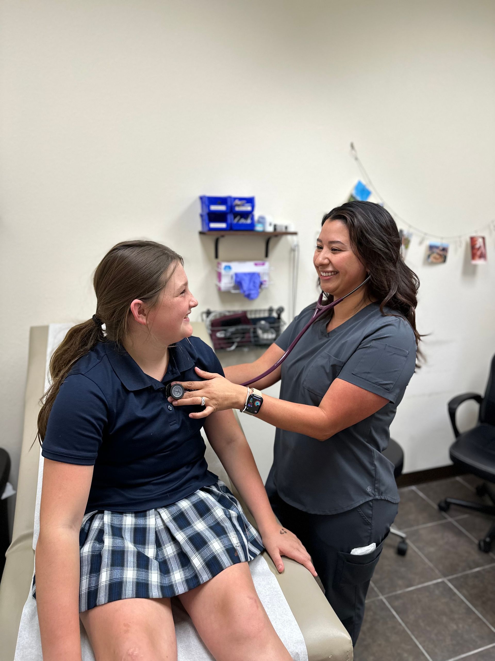A woman is using a stethoscope to listen to a girl 's heartbeat.