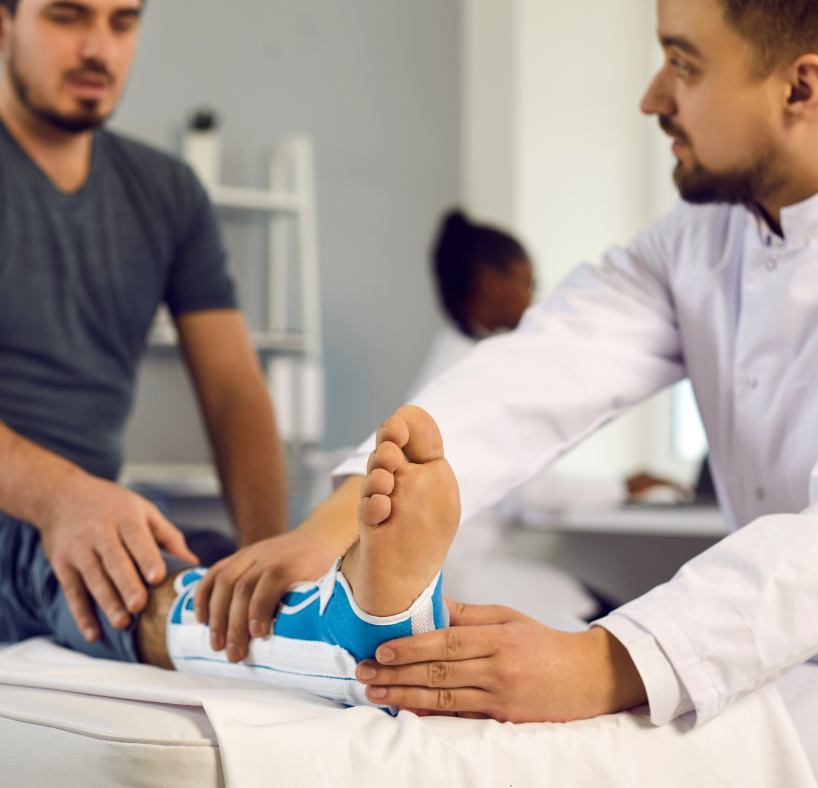 A doctor is examining a patient 's foot with a bandage on it.