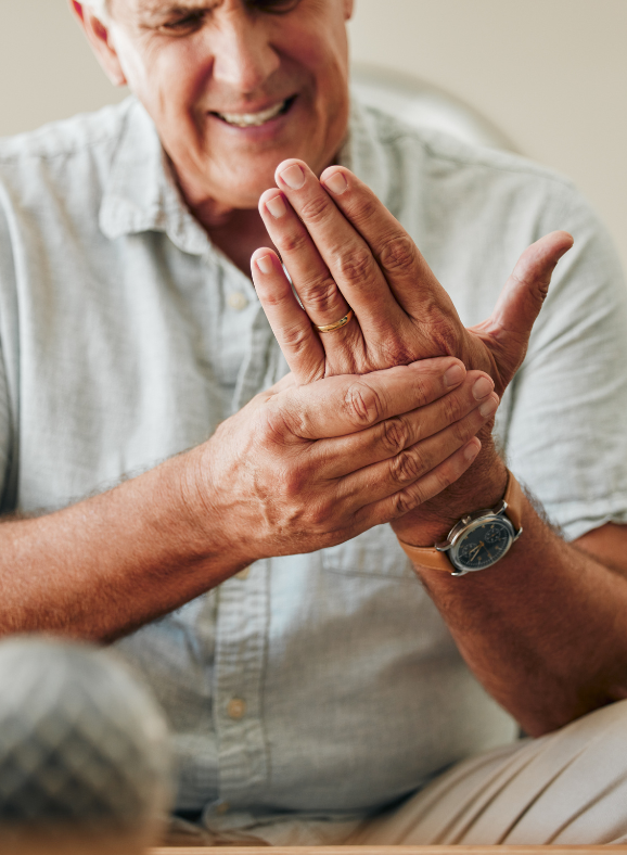A man wearing a watch is rubbing his hands together