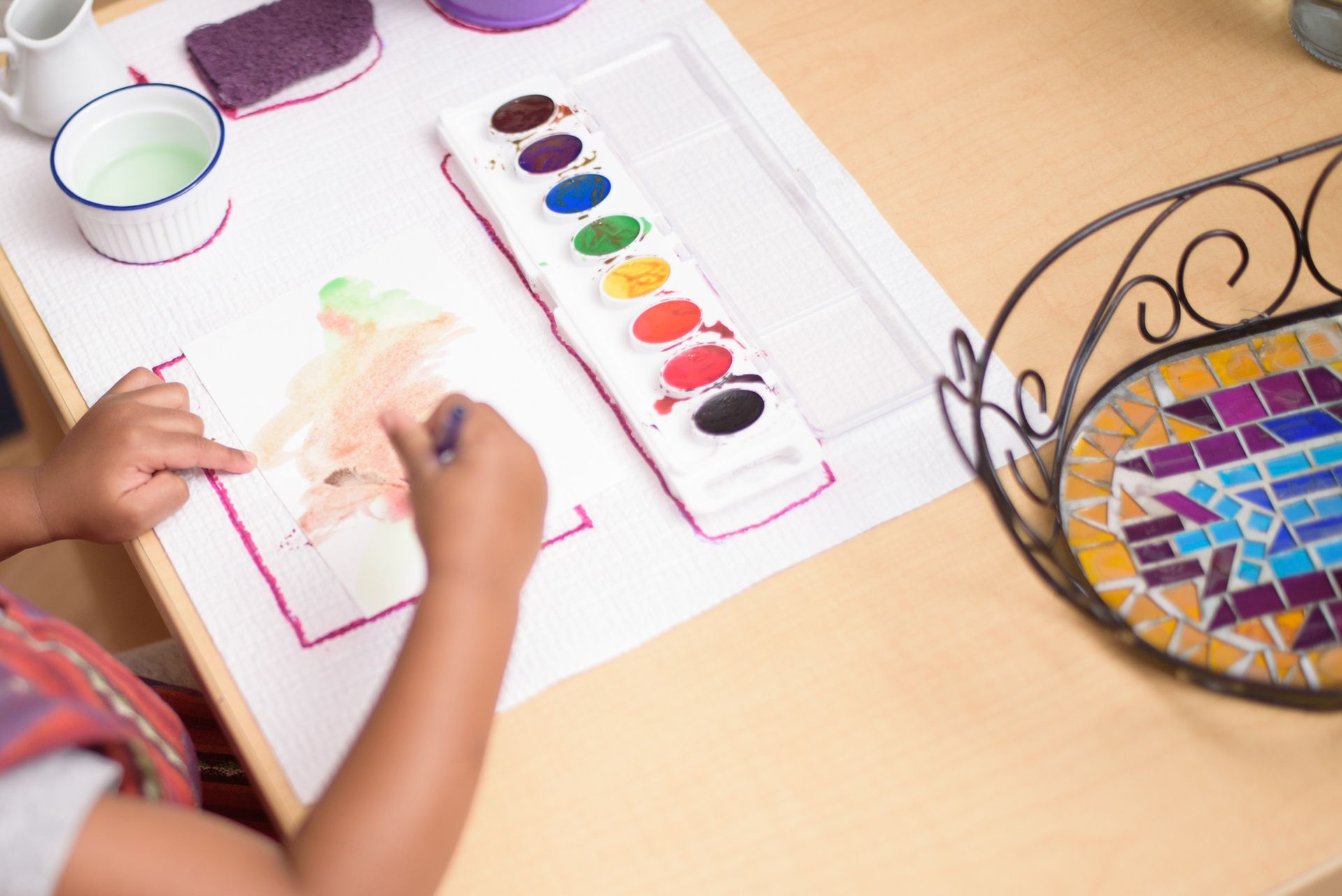 Montessori toddler painting in the classroom