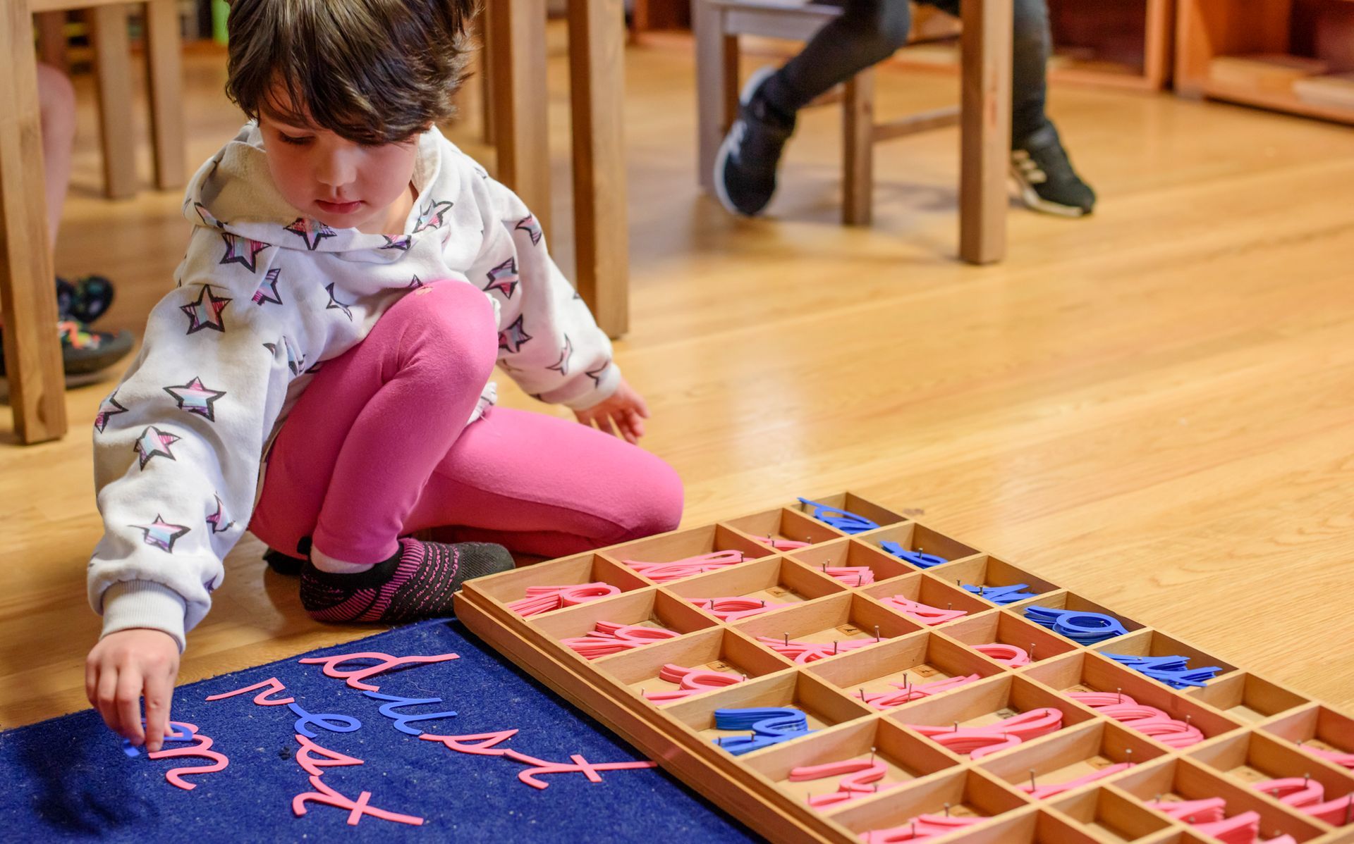 Montessori child working with language materials