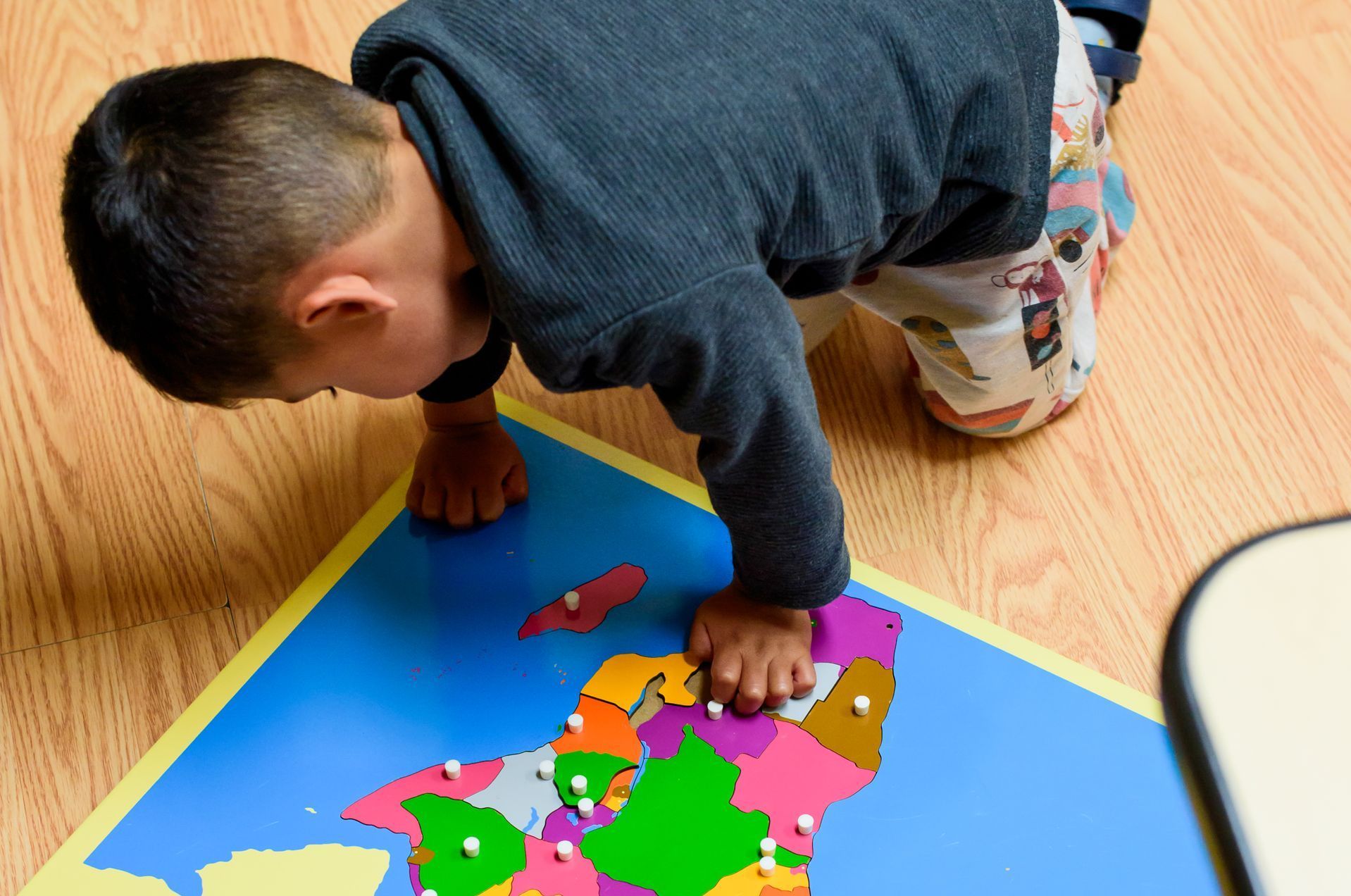 Montessori child working with cultural materials
