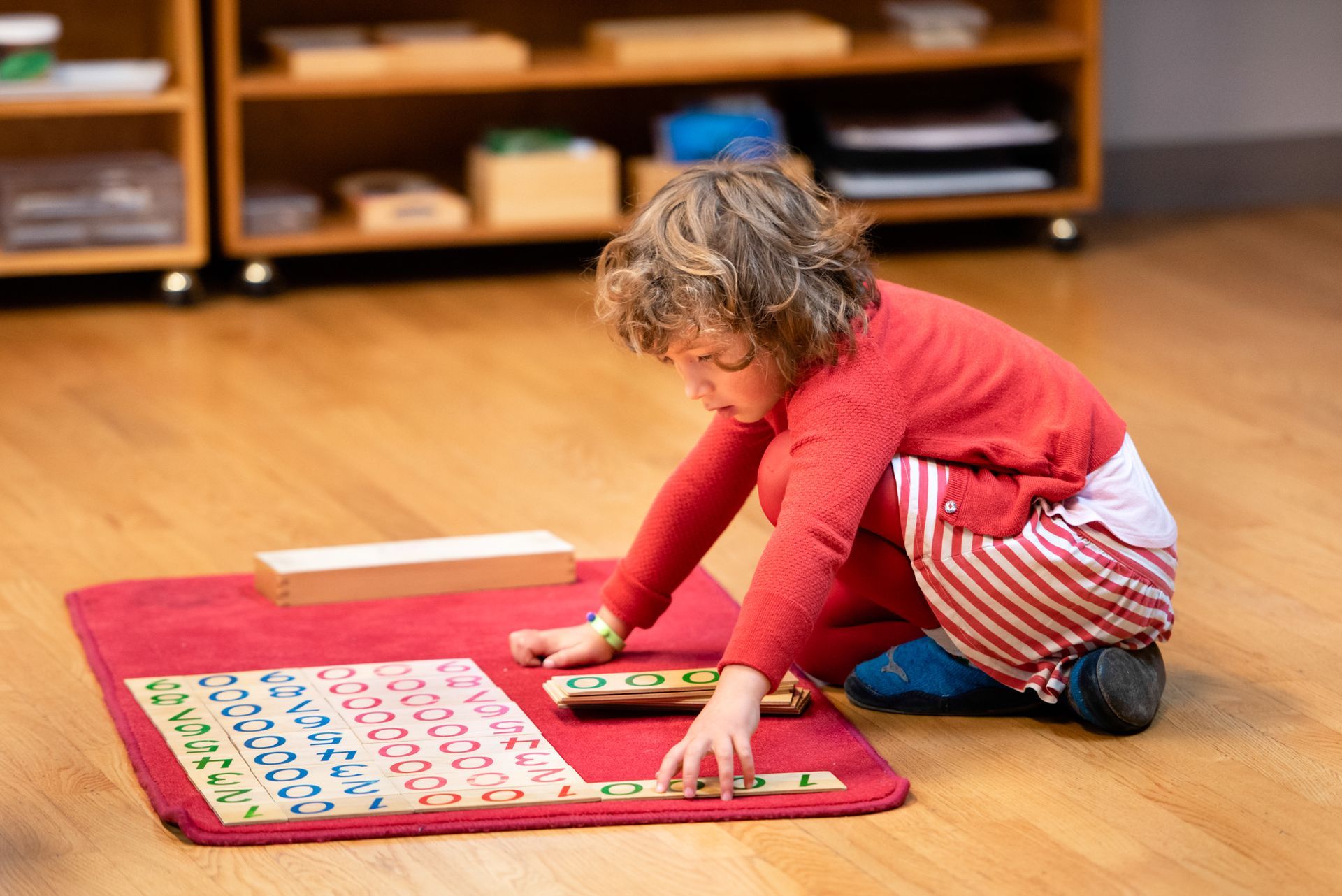 Montessori child working with math materials