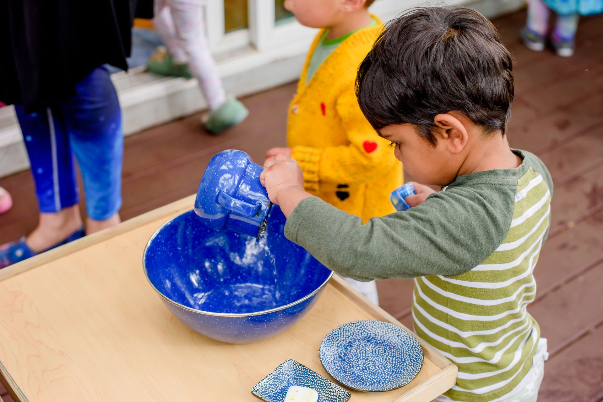 Montessori toddler working on practical life skills