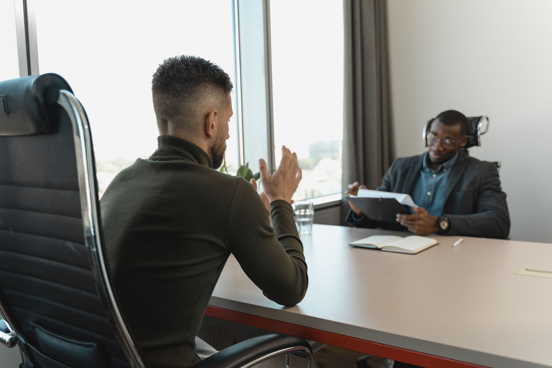 Hiring manager interviewing a candidate at a conference table