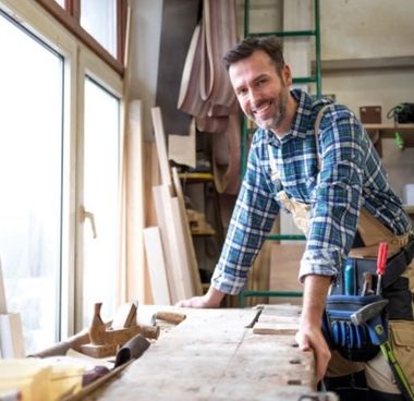 Carpenter with hands on table