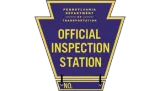 Purple and gold Pennsylvania Department of Transportation official inspection station sign with “No.” at bottom