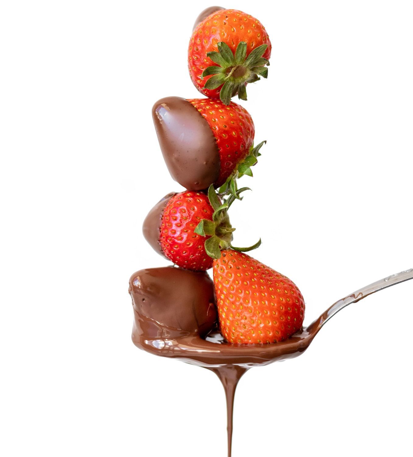 chocolate-dipped strawberries in a spoon dripping with melted chocolate
