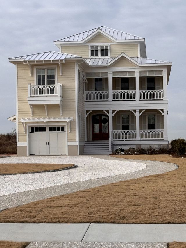 A large yellow house with a white garage door