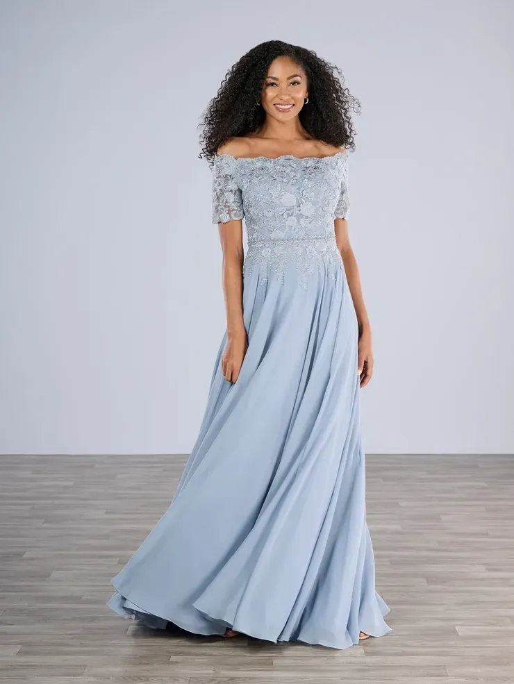 A woman is wearing a light blue off the shoulder dress.