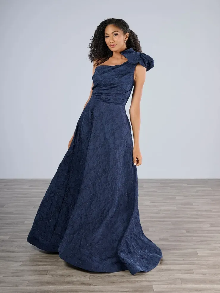 A woman is wearing a blue one shoulder dress.
