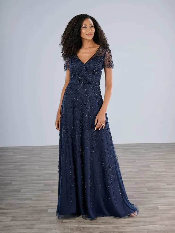 A woman is wearing a long blue dress with short sleeves.