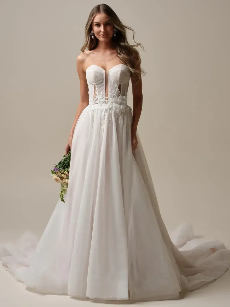 A woman is wearing a white wedding dress and holding a bouquet of flowers.