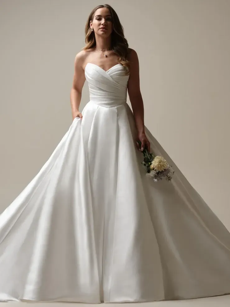 A woman in a white wedding dress is holding a bouquet of flowers.