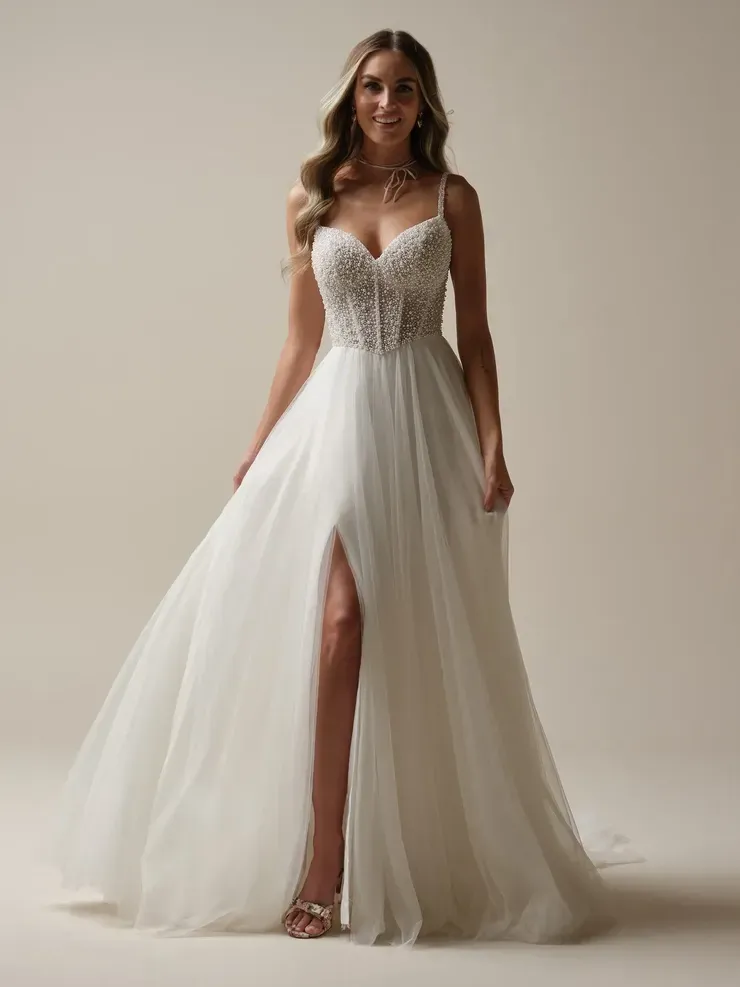 A woman is wearing a white wedding dress with a high slit.