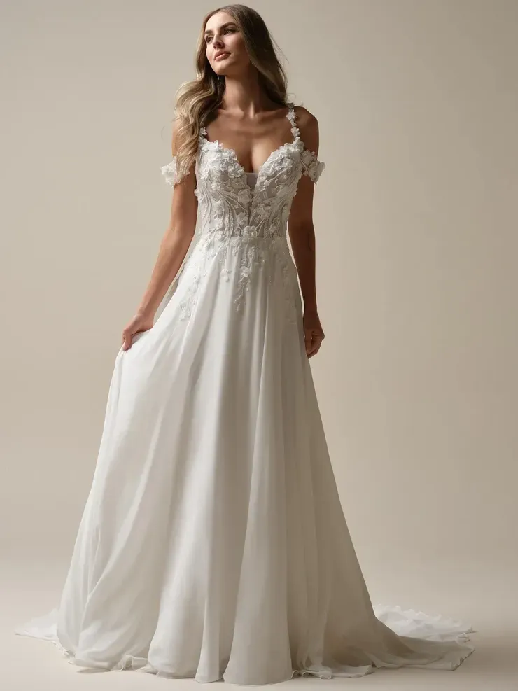 A woman is wearing a white wedding dress with a plunging neckline.