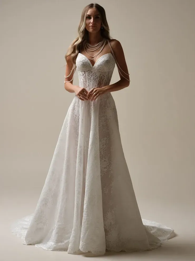 A woman is wearing a white wedding dress and a necklace.
