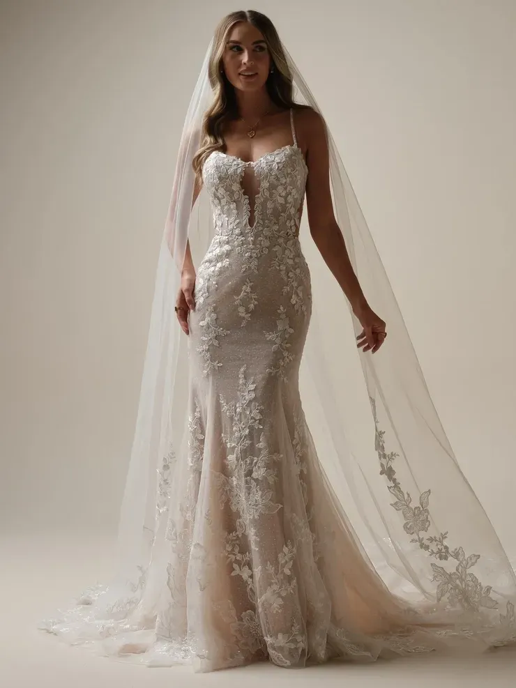 A woman is wearing a wedding dress and veil.