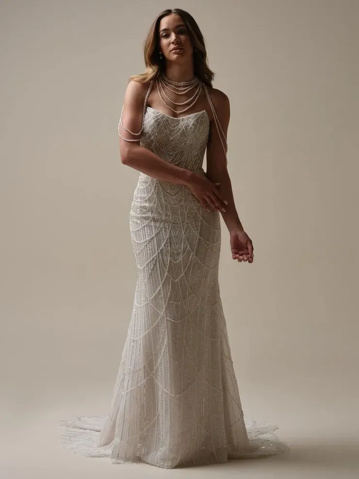 A woman is wearing a wedding dress and a necklace.