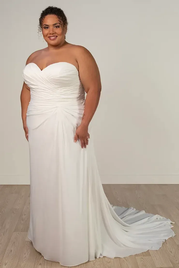 A plus size woman is wearing a white wedding dress.