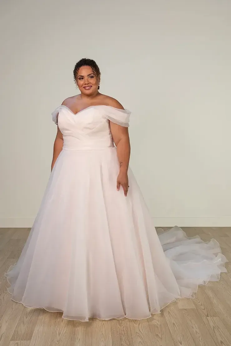 A plus size woman is wearing a white wedding dress.