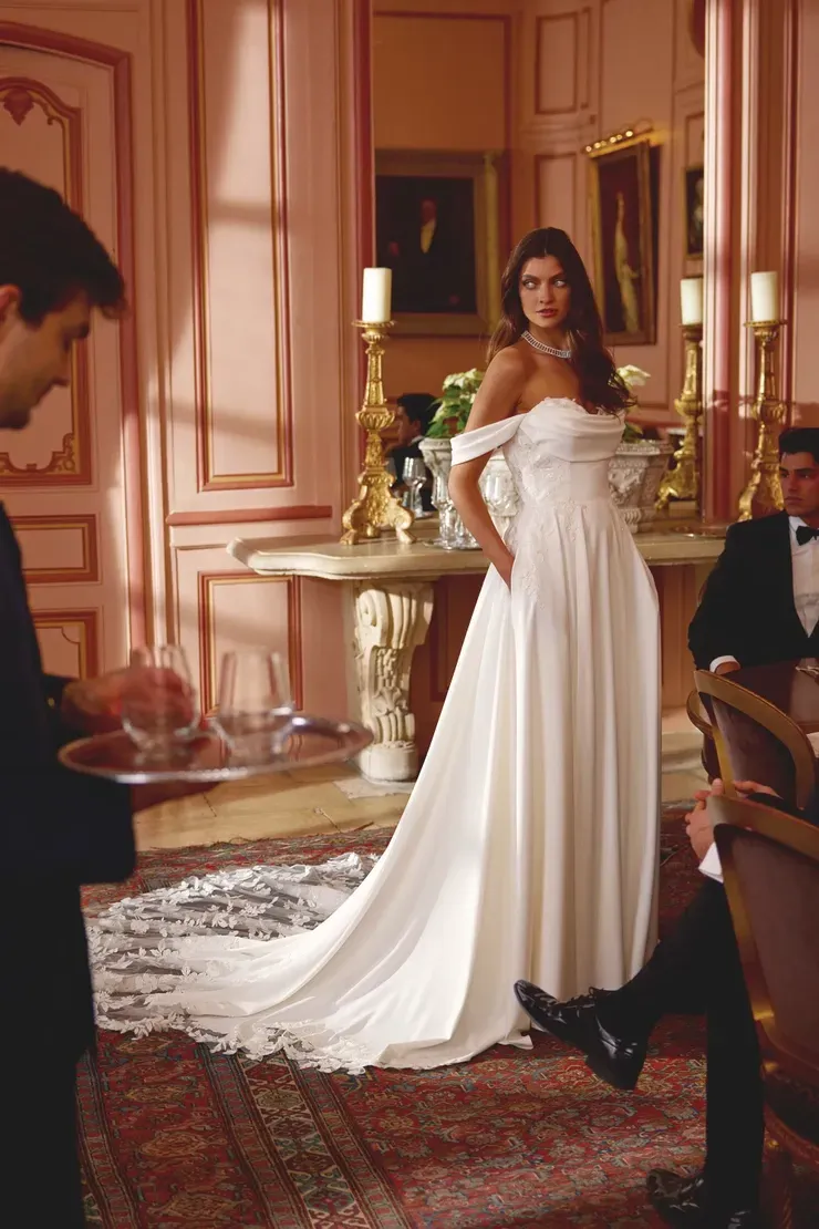 A woman in a wedding dress is standing next to a man in a tuxedo
