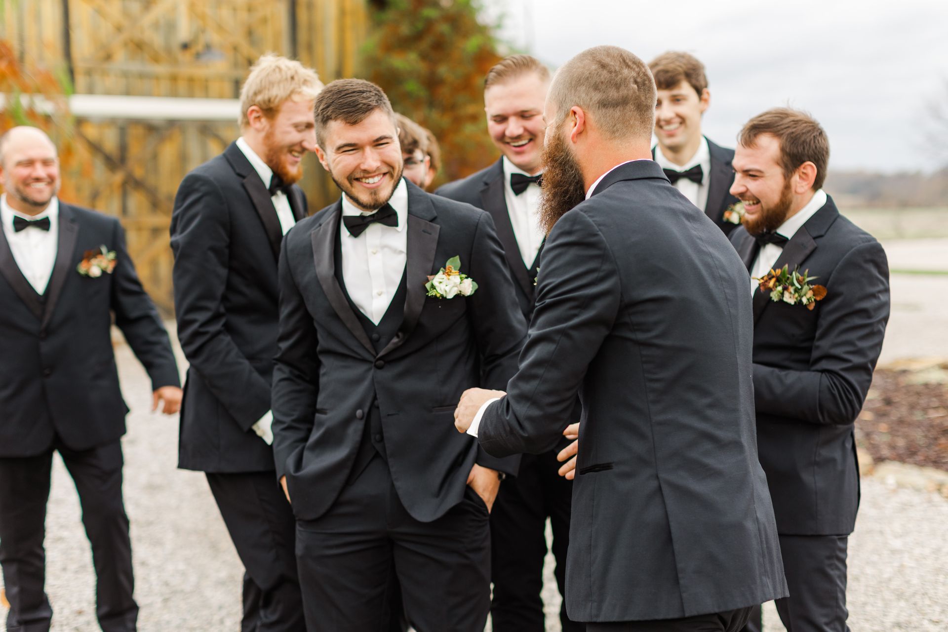 A group of men in suits and bow ties are standing next to each other.