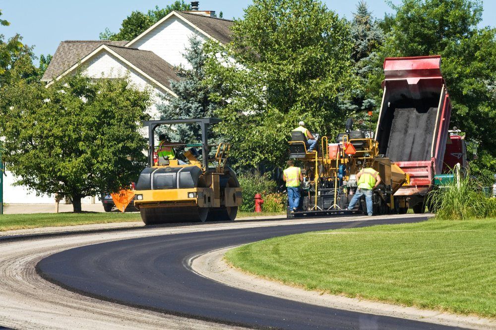 Workers working on asphalt in nice neighborhood — South Concord, NC — Smith Brothers Asphalt Paving