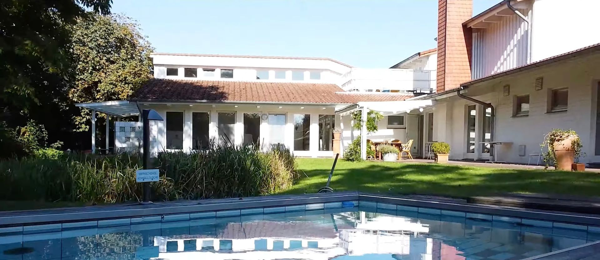 Ein großes Haus mit einem Swimmingpool davor