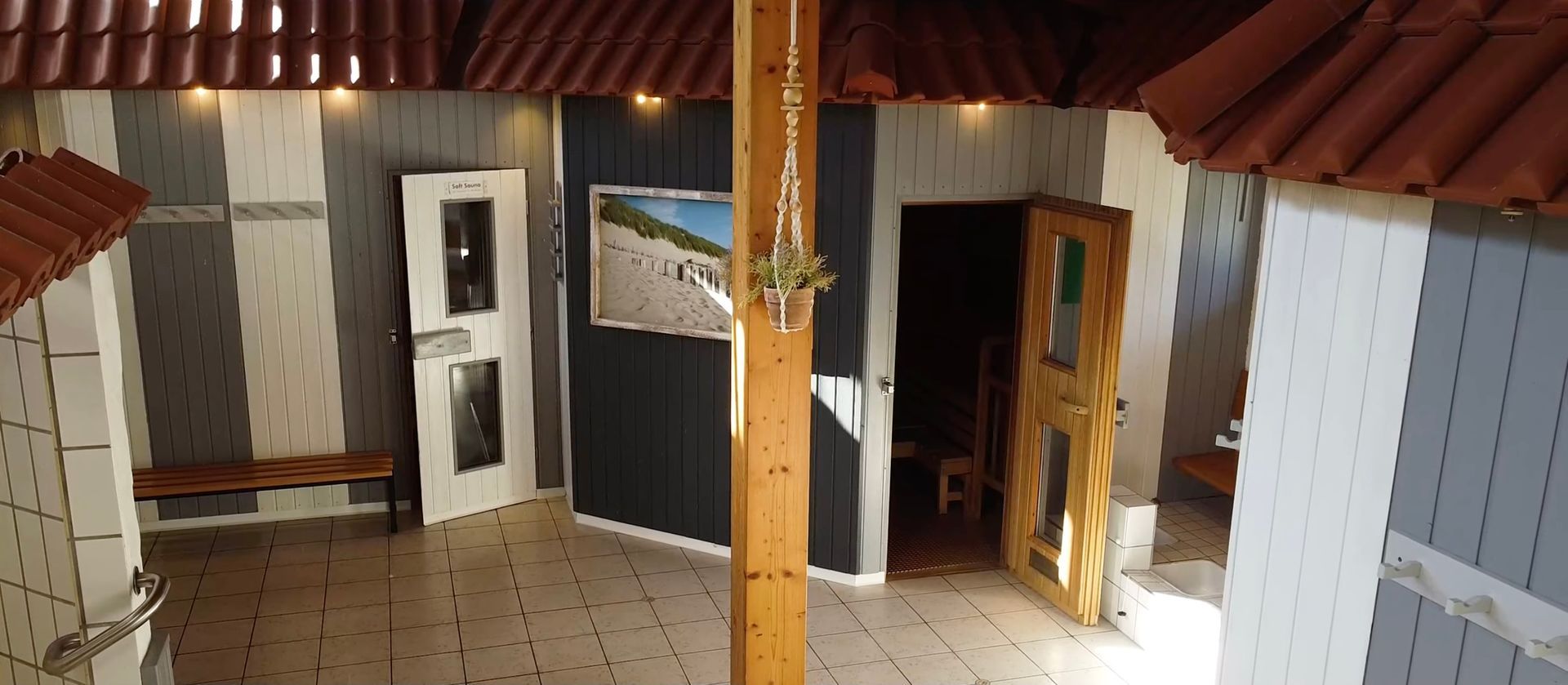 Ein Zimmer mit einem Bild von einem Strand an der Wand
