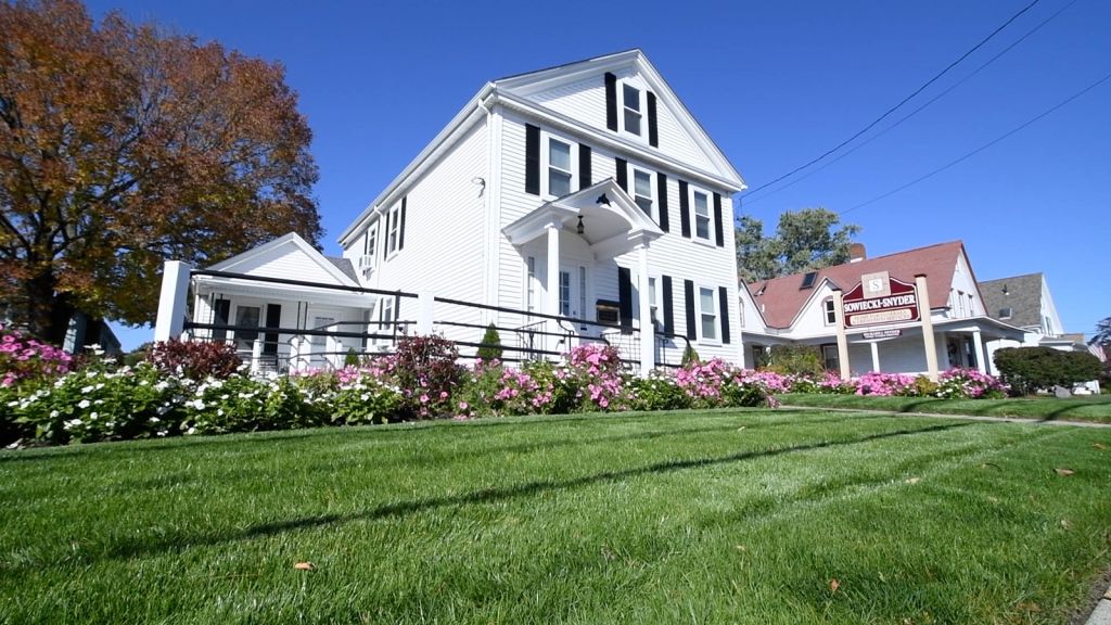 funeral home exterior white house with sign