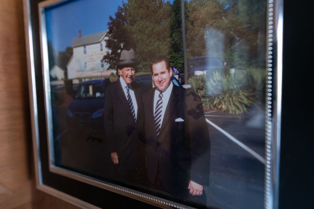 a picture of two men in suits and ties is hanging on a wall .
