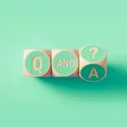 Wooden blocks spelling Q and A with a question mark, on a mint green background