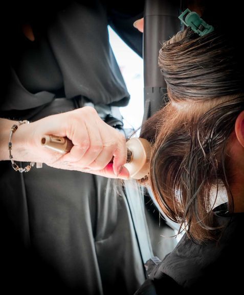 Gros plan sur une personne appliquant du maquillage à l'éponge sur le visage d'une autre personne