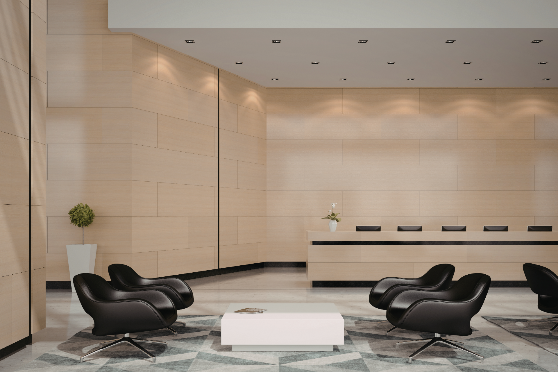 Modern lobby with light wood paneling, black leather chairs, a white coffee table, and a reception desk.