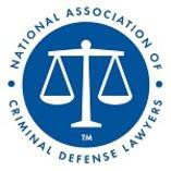 National Association of Criminal Defense Lawyers logo with white scales on a blue circle, surrounded by text