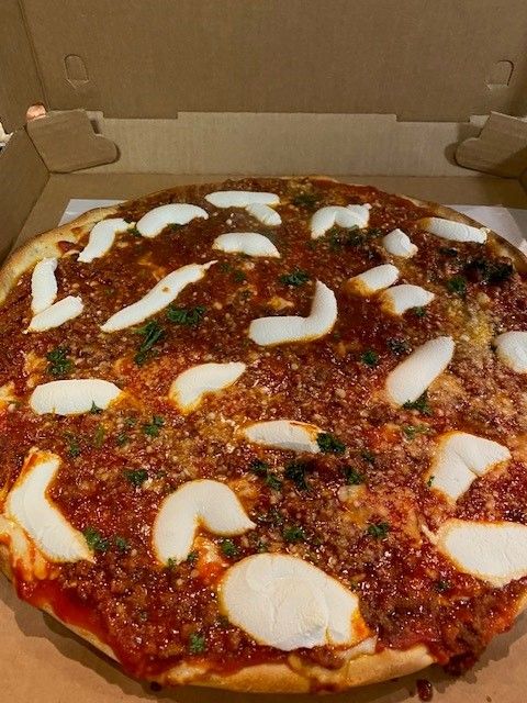 A pizza with tomato sauce and cheese is in a cardboard box