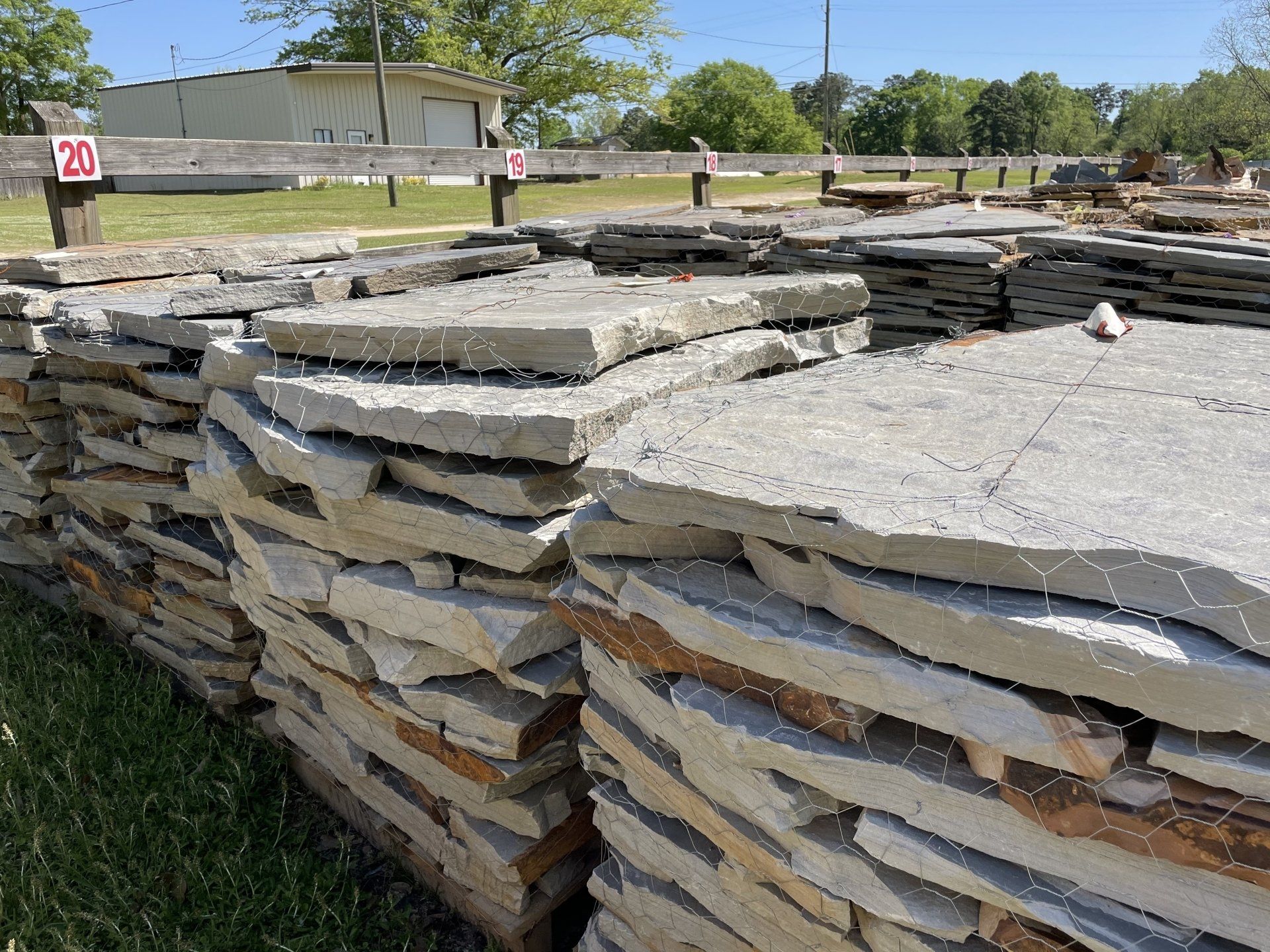 Stacks of natural stone slabs for landscaping, outdoors.