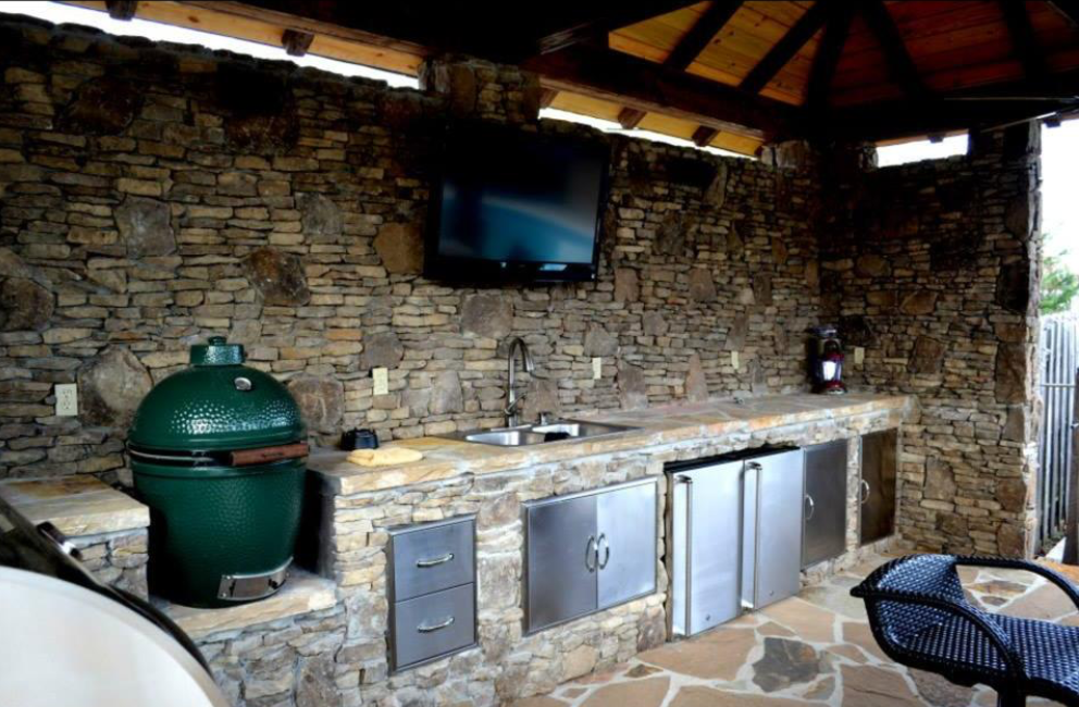 There is a large green egg in the middle of the kitchen.