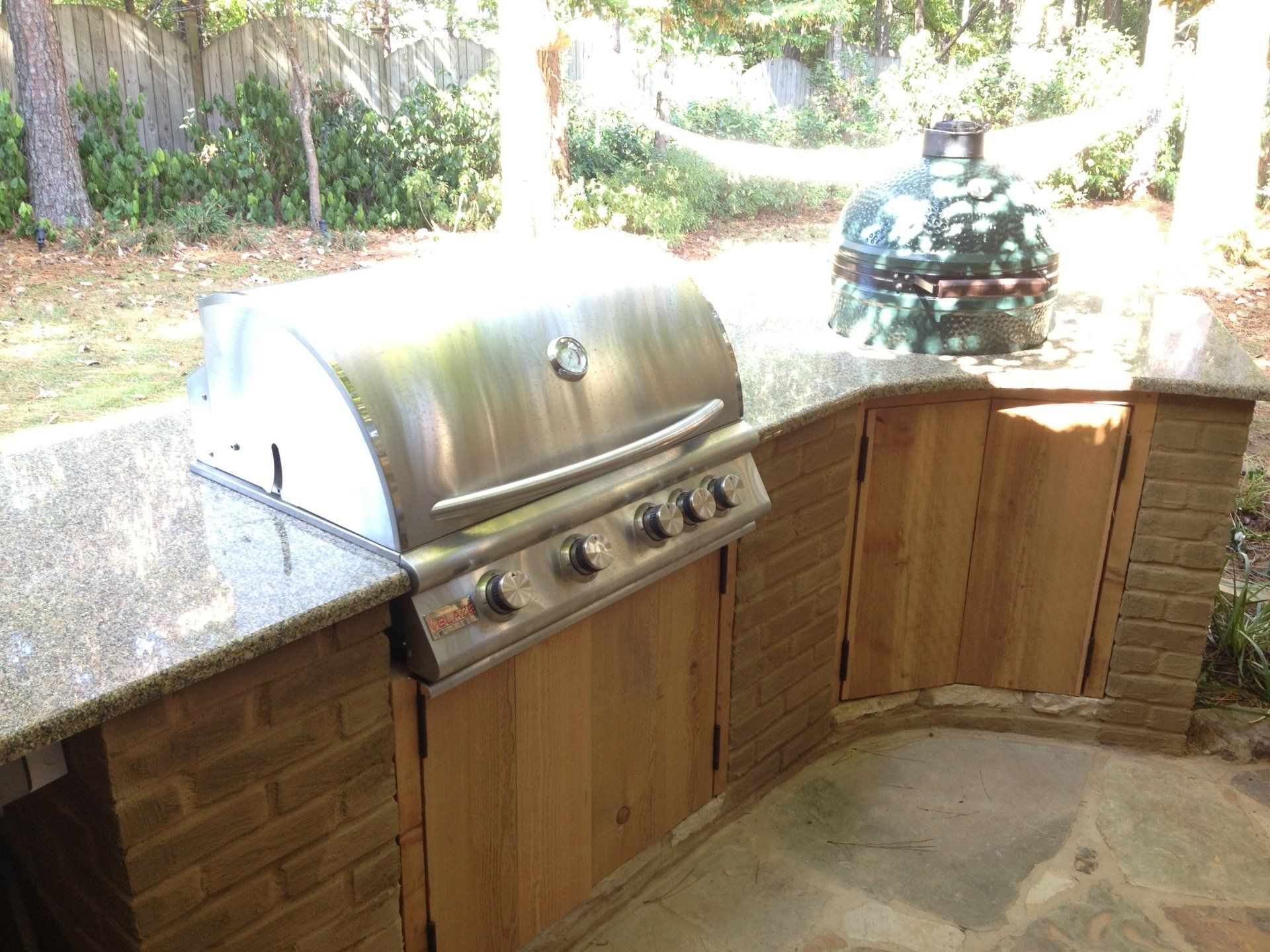 A stainless steel grill is sitting on top of a granite counter top.