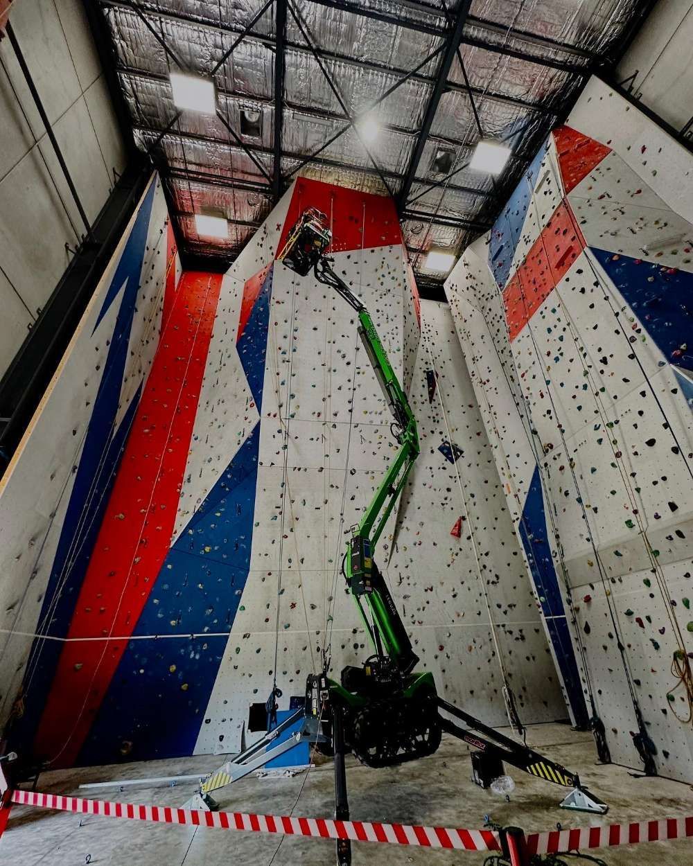 A Green Crane Is Working On A Climbing Wall Bottom View — High Work Services in Maitland, NSW