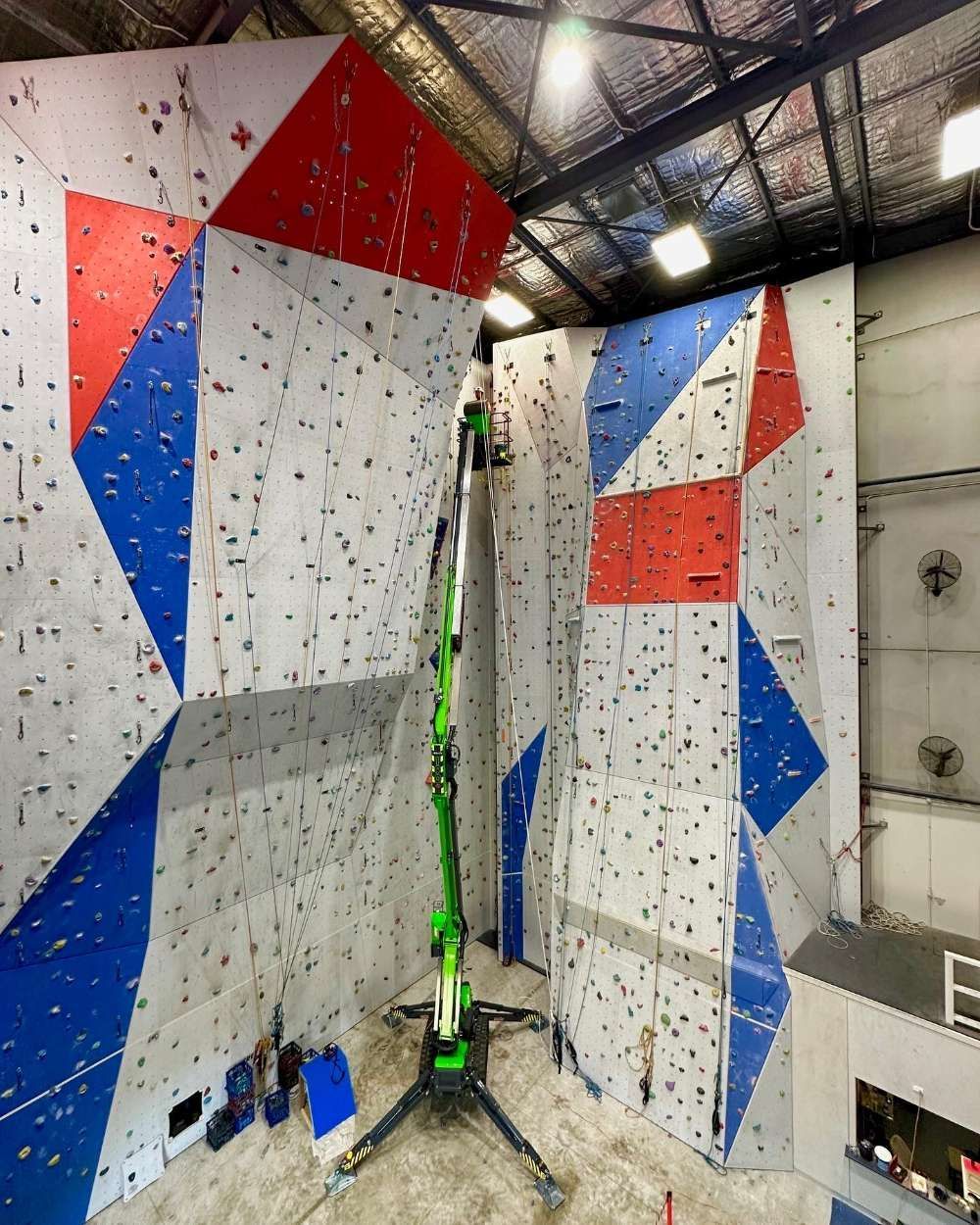 A Green Crane Is Standing In Front Of A Climbing Wall Top View — High Work Services in Maitland, NSW