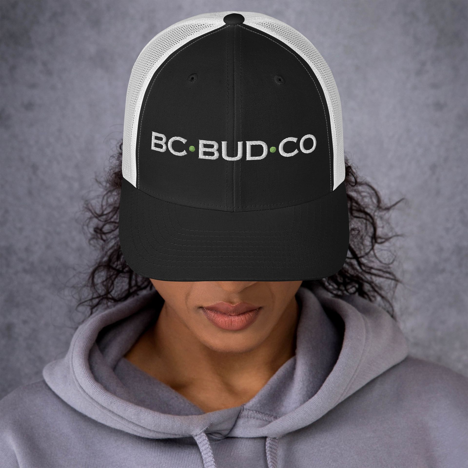 A man wearing a hat that says bc bud on it