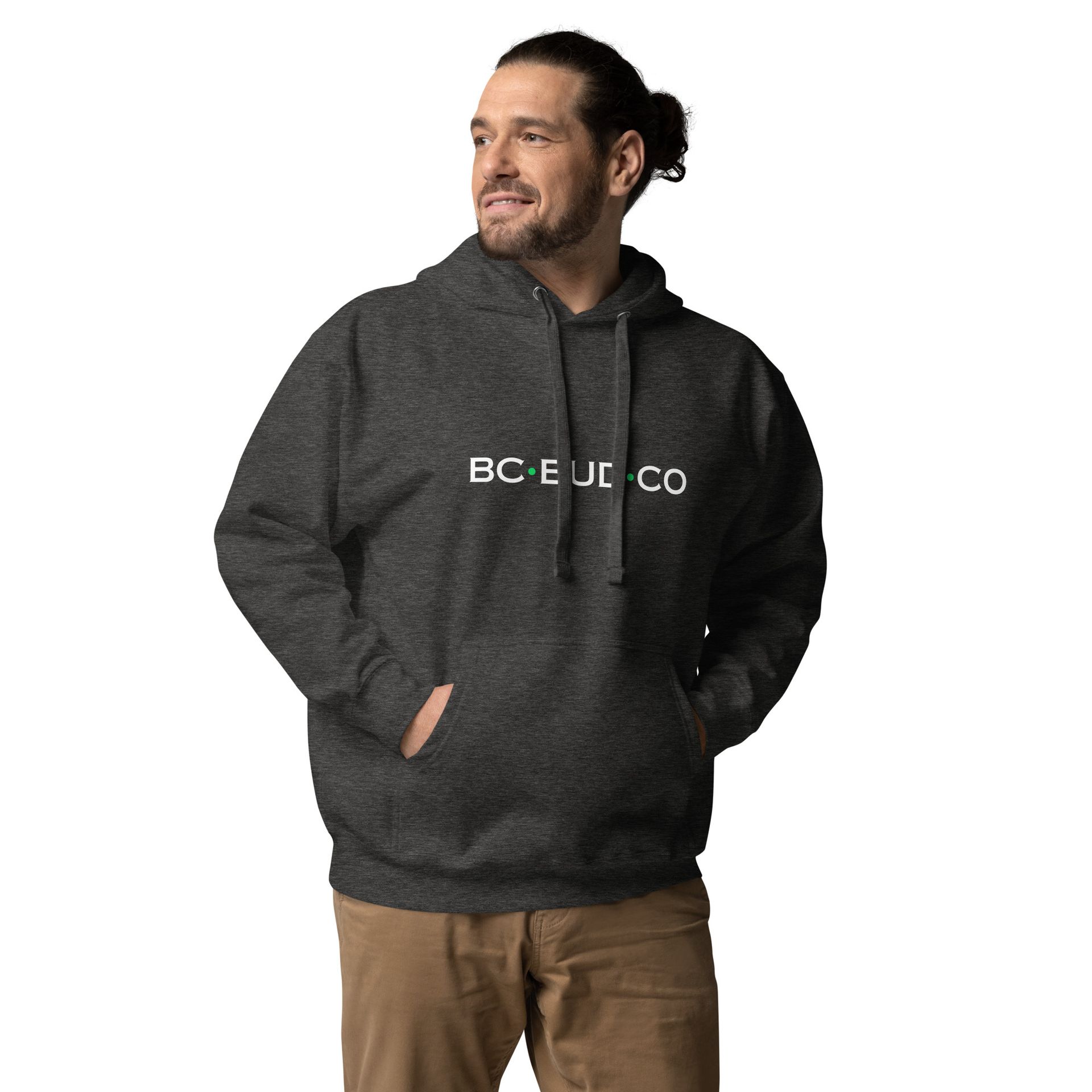 A man wearing a bc eui co hoodie stands with his hands in his pockets